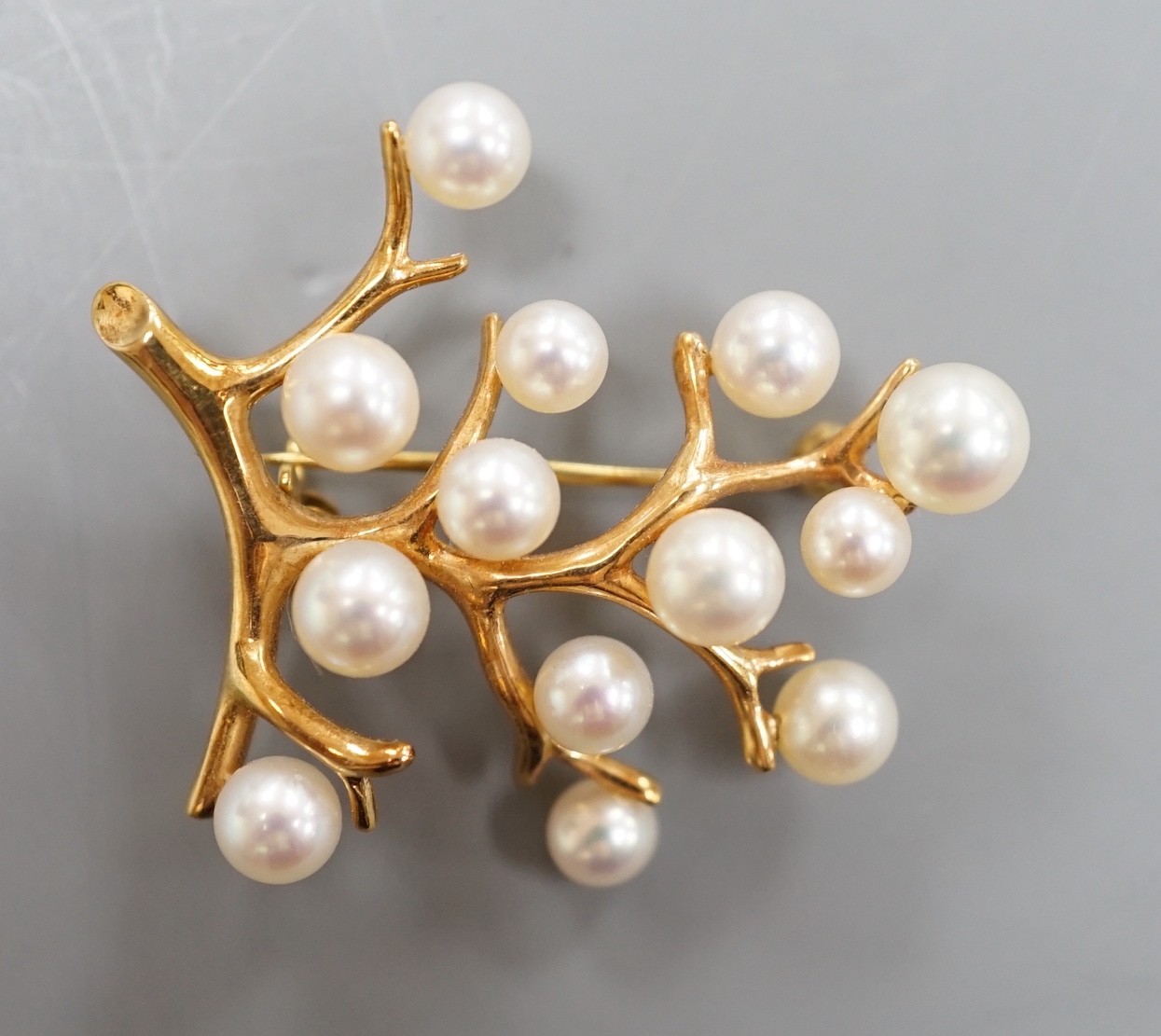 A Mikimoto 14k yellow metal and cultured pearl set cluster spray brooch, 34mm, gross weight 5.9 grams.